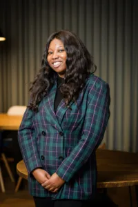 Women wearing plaid standing with her hands crossed in front of her